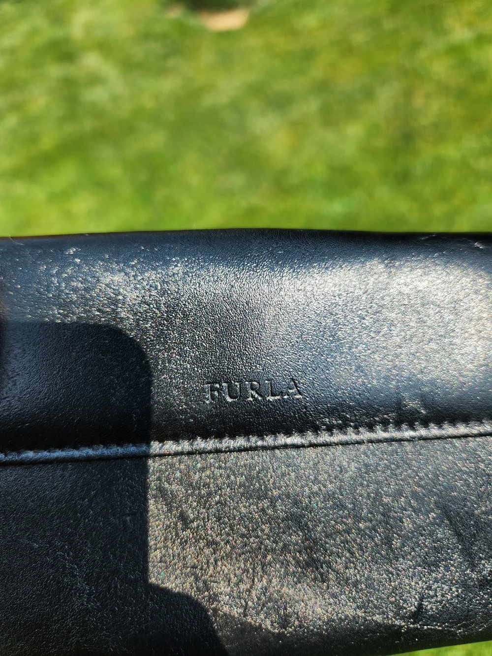 Authentic Furla trifold Compact wallet crafted from smooth black leather.
